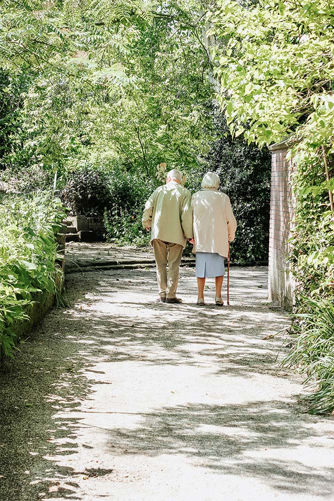 two residents walking outside together
