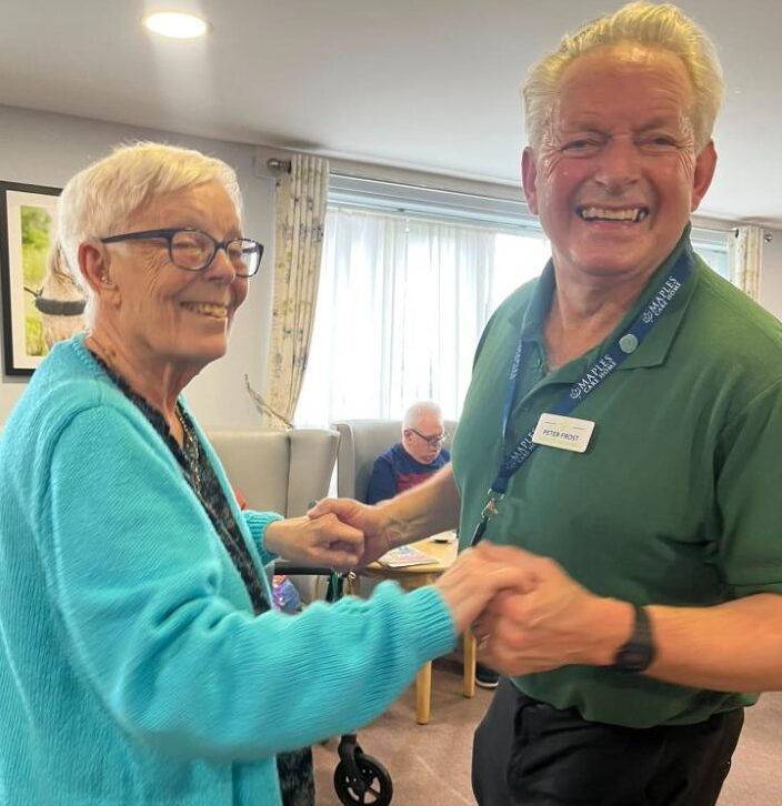 resident and staff member dancing