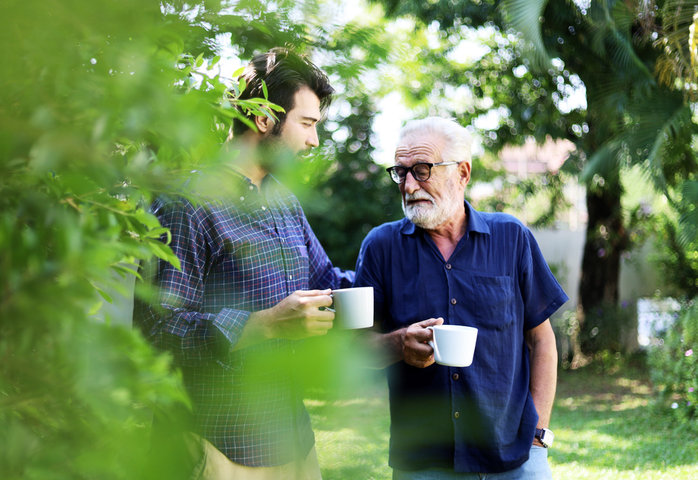 adult son talking to his father about care homes